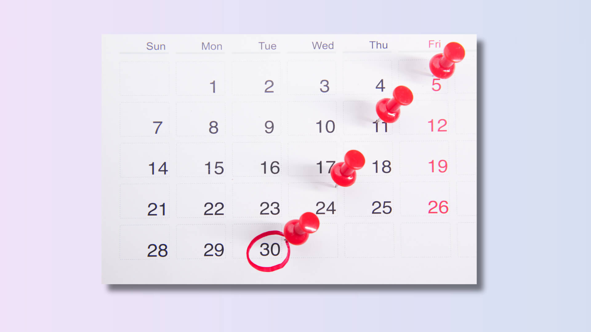 Calendar page with several dates marked by red pins, symbolizing scheduled steps and consistent progress in managing anxiety.